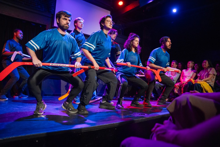 Quick and Funny Musicals ensemble performing on stage.